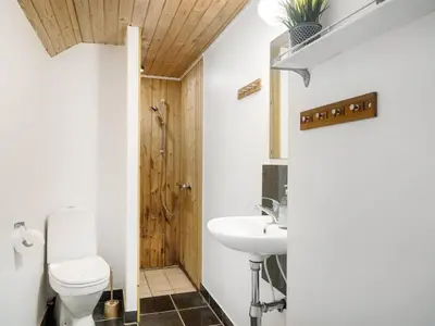 a bathroom with a toilet and a sink at Holiday Home Raika - 25m to the fjord by Interhome in Vestervig