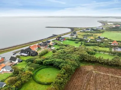 an aerial view of a house next to the water at Holiday Home Raika - 25m to the fjord by Interhome in Vestervig