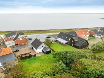 an aerial view of a group of houses next to the water at Holiday Home Raika - 25m to the fjord by Interhome in Vestervig