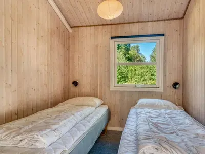 two beds in a room with a window at Holiday Home Elizabeth - 150m to the fjord by Interhome in Fur