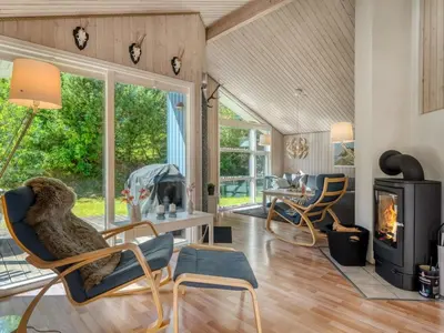 a living room with chairs and a fireplace at Holiday Home Elizabeth - 150m to the fjord by Interhome in Fur