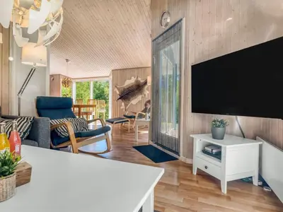 a living room with a large flat screen tv at Holiday Home Elizabeth - 150m to the fjord by Interhome in Fur