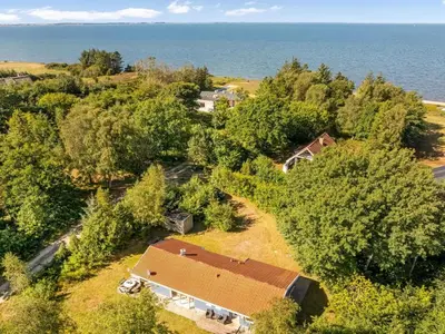 an aerial view of a house with trees and the ocean at Holiday Home Elizabeth - 150m to the fjord by Interhome in Fur