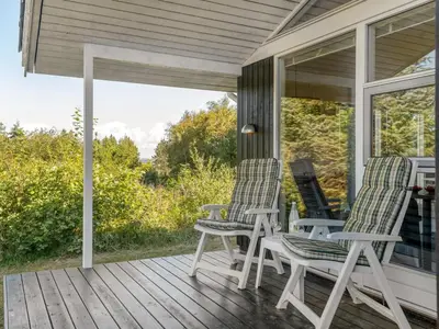 two chairs on the porch of a house at Holiday Home Marisol - 250m to the fjord by Interhome in Fur