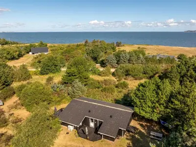 an aerial view of a house with the ocean in the background at Holiday Home Marisol - 250m to the fjord by Interhome in Fur