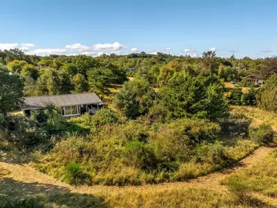 a house on top of a hill with trees at Holiday Home Marisol - 250m to the fjord by Interhome in Fur