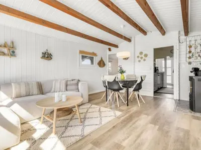 a living room with a couch and a table at Holiday Home Berner - 500m to the fjord by Interhome in Roslev