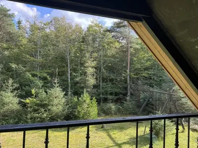 a window in a tent looking out at the forest at Holiday Home Karmen - 1km from the sea by Interhome in Pandrup