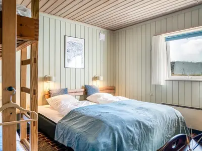 a bedroom with a bed and a window at Apartment Enwald - 700m from the sea by Interhome in Pandrup
