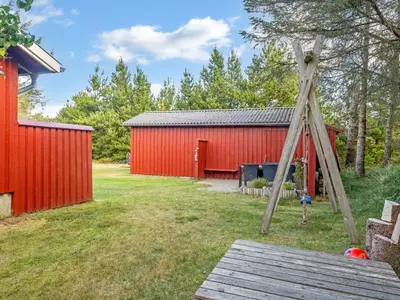 a ladder in front of a red shed at Holiday Home Ingobert - 600m from the sea by Interhome in Saltum