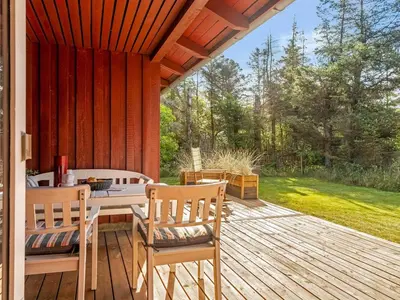 a patio with a table and chairs on a deck at Holiday Home Ingobert - 600m from the sea by Interhome in Saltum