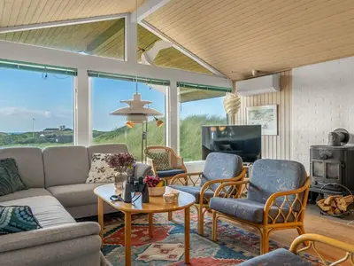 a living room with a couch and chairs and a tv at Holiday Home Myrna - 250m from the sea by Interhome in Saltum