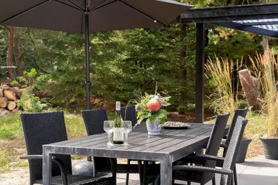 a black table with chairs and an umbrella at 1357-Snedsted-Grahavrevej-1 in Snedsted