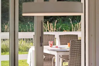 a white table and chairs on a patio at LK2192-Lokken-Magdalenevej-18 in Løkken
