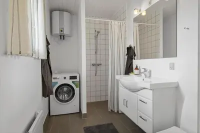 a white bathroom with a washing machine and a sink at BL1123-Saltum-Jydske-Rev-5 in Saltum