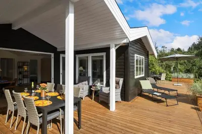 a patio with a table and chairs on a deck at BL1123-Saltum-Jydske-Rev-5 in Saltum