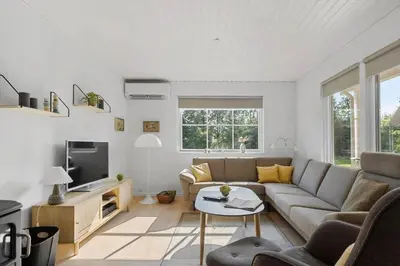 a living room with a couch and a tv at BL1123-Saltum-Jydske-Rev-5 in Saltum
