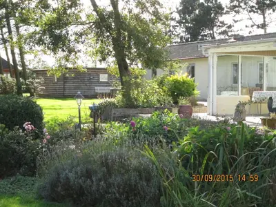 a garden in front of a house at Bakkegården Homestay in Spottrup