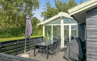 a patio with a table and a gazebo at Awesome Home In Farsø With Sauna in Farsø
