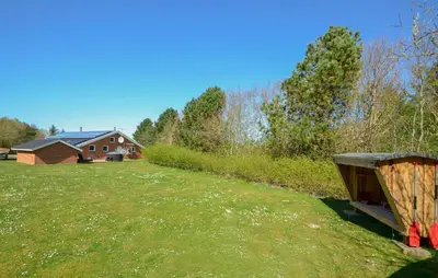 a yard with a house in the background at Ocean Front Home In Spøttrup With Sauna in Spottrup