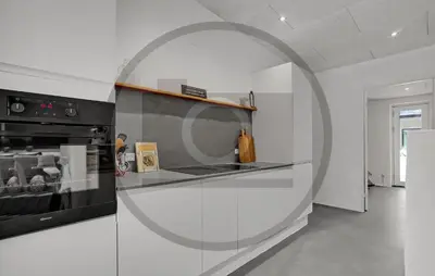 a white kitchen with a black stove top oven at 4 Bedroom Awesome Home In Thyholm in Thyholm