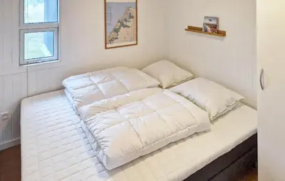 a bed in a room with two pillows on it at Gorgeous Home In Thisted With House A Panoramic View in Thisted