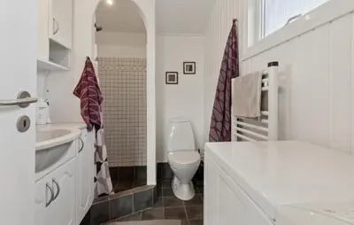 a white bathroom with a toilet and a sink at Gorgeous Home In Thisted With House A Panoramic View in Thisted