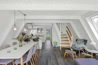 a kitchen and dining room with a table and chairs at Holiday Home At Himmerland Golf & Spa Resort in Farsø