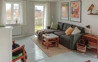 a living room with a couch and a table at Lovely Home In Thyborøn With Wifi in Thyborøn