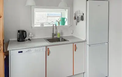a kitchen with a sink and a white refrigerator at Lovely Home In Thyborøn With Wifi in Thyborøn