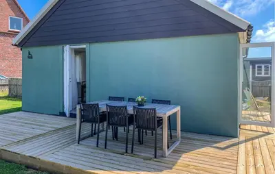 a patio with a table and chairs on a deck at Lovely Home In Thyborøn With Wifi in Thyborøn