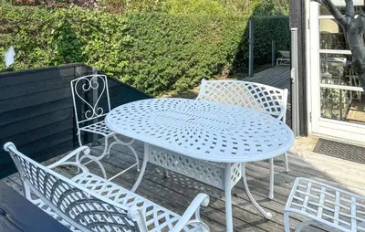 a blue table and chairs sitting on a deck at Gorgeous Home In Farsø With Wifi in Farsø