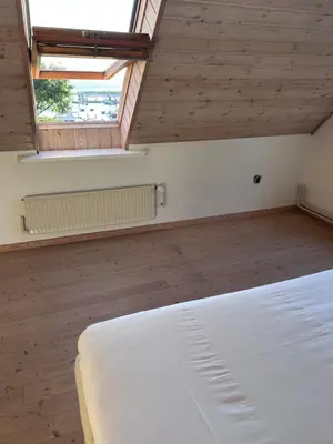 a bedroom with a white bed and a window at Udsigtsvilla Tambohus in Thyholm