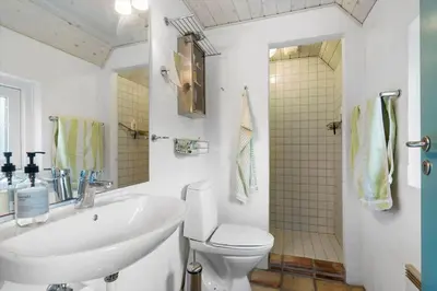 a bathroom with a sink and a toilet and a shower at BL1120-Saltum-Kohlsvej-15 in Saltum