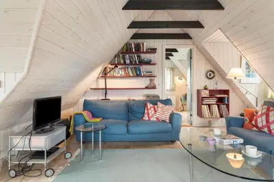 a living room with a blue couch and a tv at BL1120-Saltum-Kohlsvej-15 in Saltum