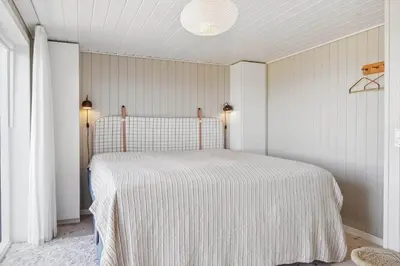 a bedroom with a bed with a striped blanket at BL1126-Saltum-Porsevej-14 in Saltum