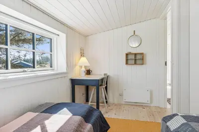 a bedroom with a bed and a desk and a window at BL1126-Saltum-Porsevej-14 in Saltum