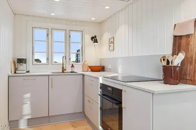 a white kitchen with white cabinets and a sink at BL1126-Saltum-Porsevej-14 in Saltum