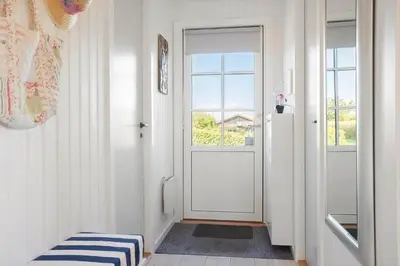 a hallway with a white door and a window at LF14058-Roslev-Eskovvej-58 in Roslev