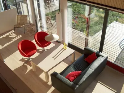 a living room with a couch and two red chairs at Holiday home in Thisted with swimming pool in Thisted