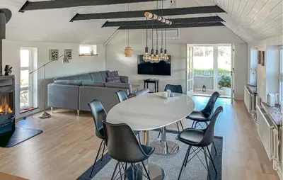 a living room with a white table and chairs at 3 Bedroom Nice Home In Blokhus in Blokhus