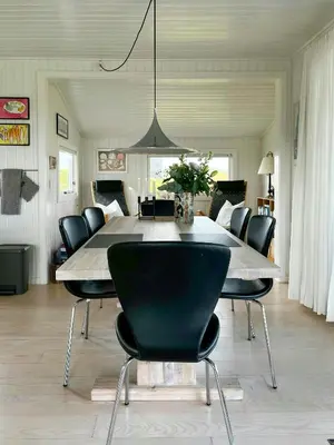 a dining room with a large table and chairs at Family House Close To The Sea At Tranum Strand in Brovst