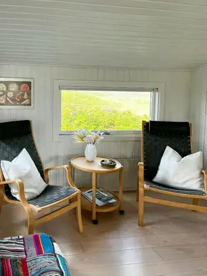 a room with two chairs and a table and a window at Family House Close To The Sea At Tranum Strand in Brovst