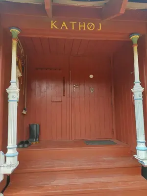 a red door with a sign that reads khalili at Kathøje in Lemvig