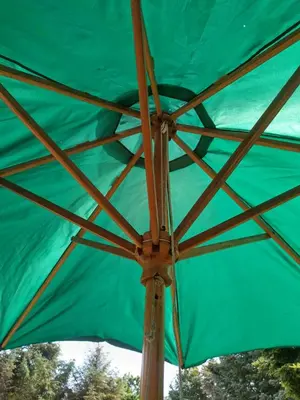 a green umbrella with a wooden pole at Kathøje in Lemvig