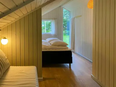 a bedroom with two beds in a room with a window at Holiday Home Between Beach And Forest On Mors in Øster Assels