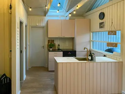 a kitchen with white cabinets and a sink at Holiday Home Between Beach And Forest On Mors in Øster Assels