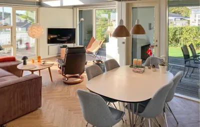 a living room with a table and chairs at 3 Bedroom Gorgeous Home In Hurup Thy in Doverodde