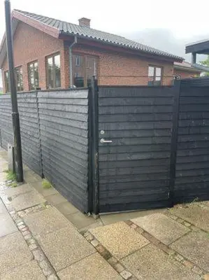 a black fence in front of a house at Østerbrogade 49 in Holstebro