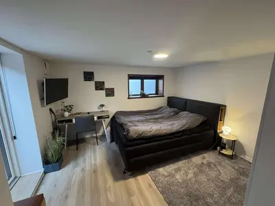 a bedroom with a bed and a desk in it at Østerbrogade 49 in Holstebro